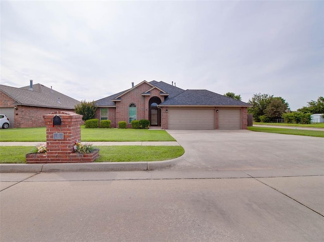 1201 W Churchill Way, Mustang, OK 73064 - ranch-style home with a garage, brick siding, a front lawn, driveway, and a shingled roof