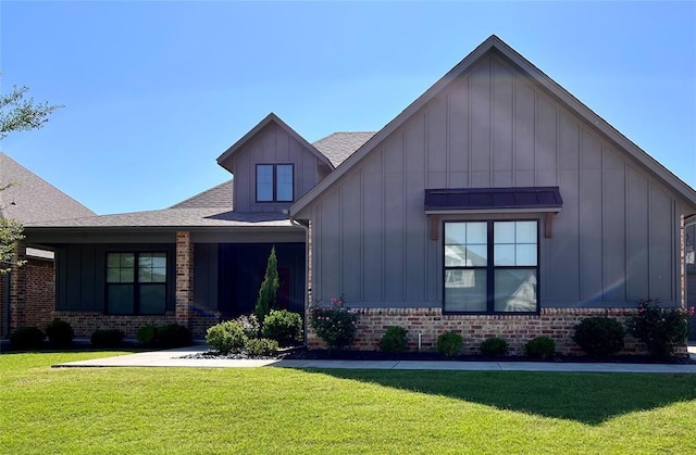 16405 Brookefield Dr, Edmond, OK 73013 - view of front facade with board and batten siding, a front lawn, and brick siding