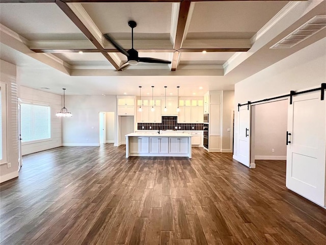 16405 Brookefield Dr, Edmond, OK 73013 - kitchen featuring a barn door, white cabinetry, a ceiling fan, dark wood finished floors, and coffered ceiling