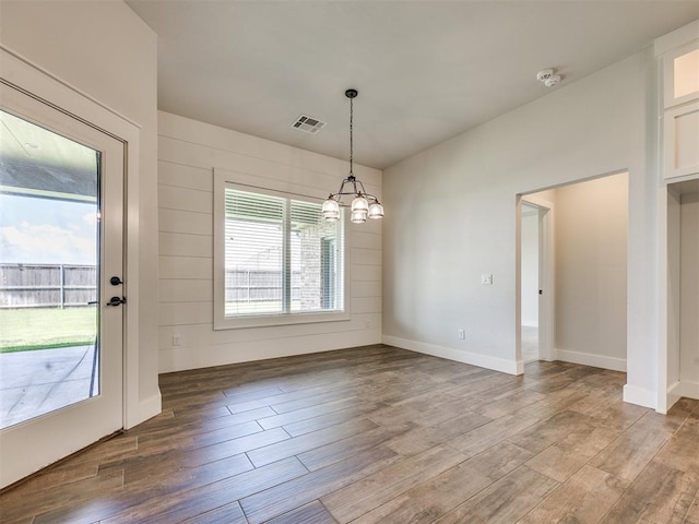 16405 Brookefield Dr, Edmond, OK 73013 - unfurnished dining area featuring a chandelier and wood finished floors