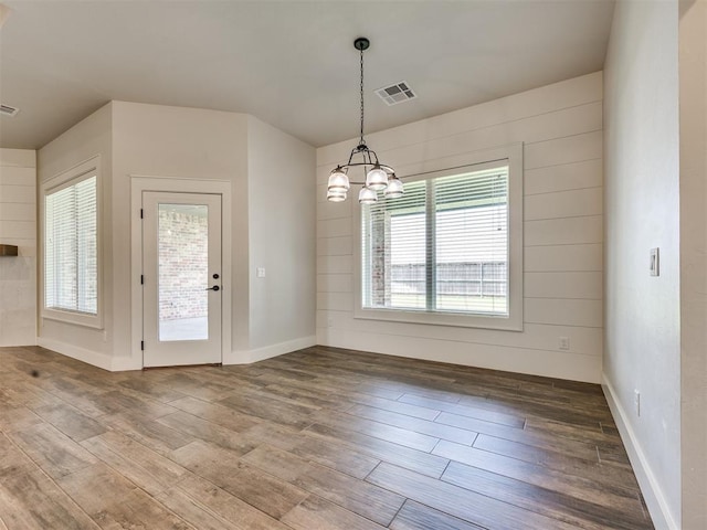 16405 Brookefield Dr, Edmond, OK 73013 - unfurnished dining area with wood-type flooring and a chandelier
