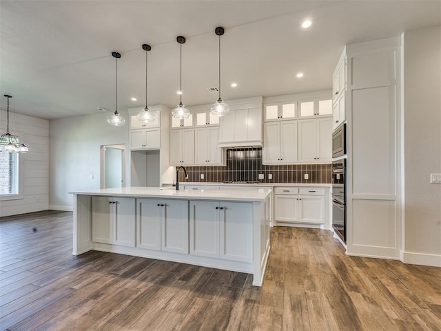 16405 Brookefield Dr, Edmond, OK 73013 - kitchen with appliances with stainless steel finishes, premium range hood, white cabinetry, light countertops, and dark wood-style flooring