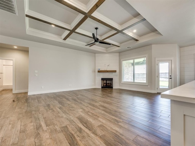 16405 Brookefield Dr, Edmond, OK 73013 - unfurnished living room featuring ceiling fan, light wood finished floors, beam ceiling, a fireplace, and coffered ceiling