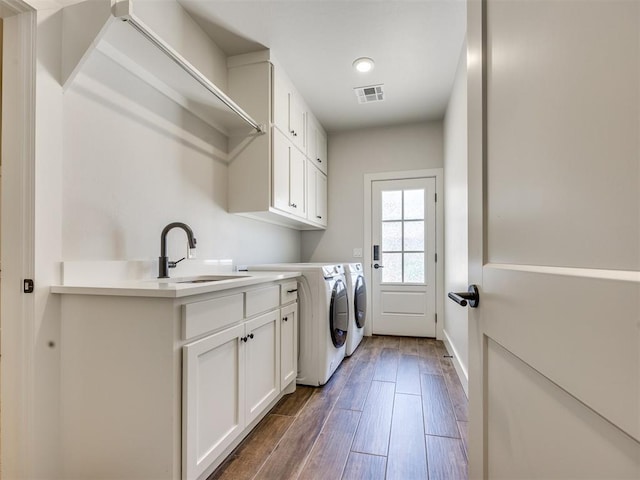 16405 Brookefield Dr, Edmond, OK 73013 - laundry room with cabinet space, separate washer and dryer, and wood finished floors