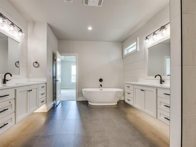 16405 Brookefield Dr, Edmond, OK 73013 - full bath featuring a soaking tub, two vanities, and plenty of natural light
