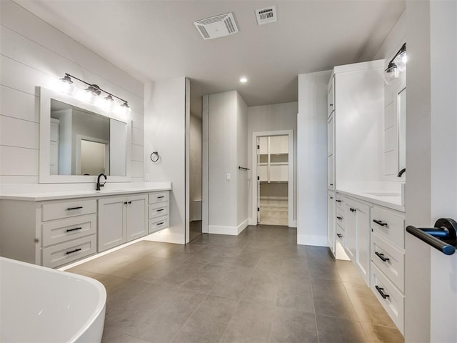 16405 Brookefield Dr, Edmond, OK 73013 - bathroom with two vanities, a freestanding bath, recessed lighting, and tile patterned flooring