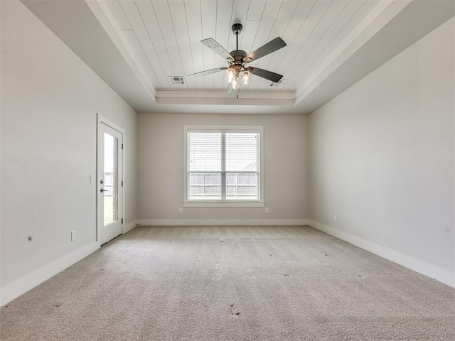16405 Brookefield Dr, Edmond, OK 73013 - unfurnished room featuring a tray ceiling, light colored carpet, wood ceiling, and a ceiling fan