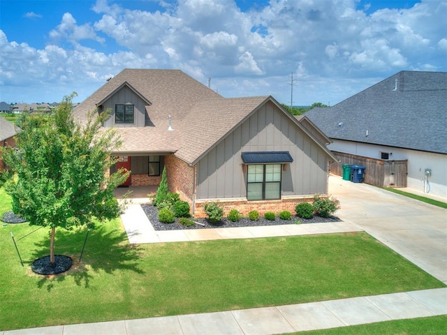 16405 Brookefield Dr, Edmond, OK 73013 - view of front of property featuring board and batten siding, brick siding, roof with shingles, and concrete driveway