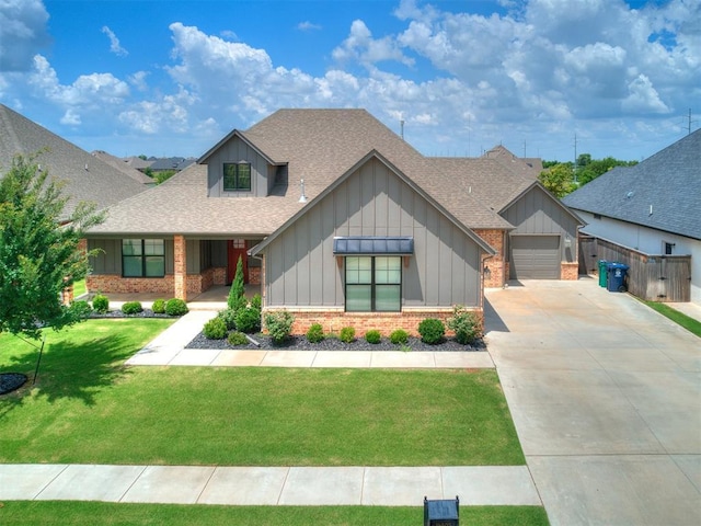 16405 Brookefield Dr, Edmond, OK 73013 - view of front of home with brick siding, board and batten siding, a shingled roof, concrete driveway, and a front lawn