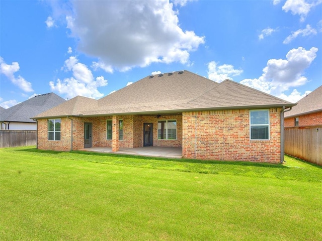 16405 Brookefield Dr, Edmond, OK 73013 - back of property with a fenced backyard, a patio area, brick siding, and a shingled roof