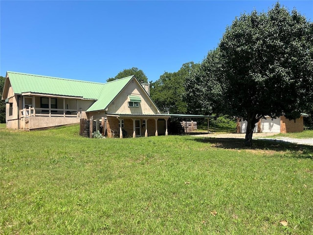 4179 W Gatlin St, Duncan, OK 73535 - rear view of property with a yard, a metal roof, and driveway