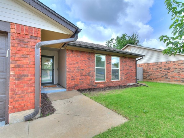 1408 Chimney Hill Rd, Yukon, OK 73099 - doorway to property featuring a yard and brick siding