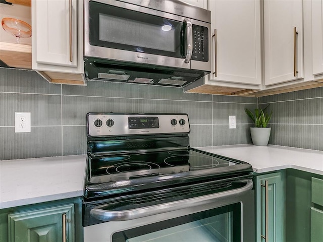 1408 Chimney Hill Rd, Yukon, OK 73099 - kitchen with appliances with stainless steel finishes, decorative backsplash, and white cabinetry