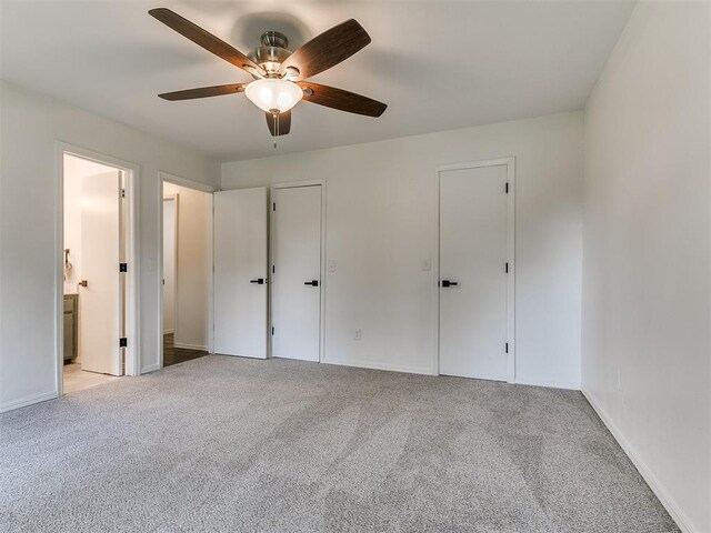 1408 Chimney Hill Rd, Yukon, OK 73099 - unfurnished bedroom featuring light colored carpet, ensuite bathroom, and a ceiling fan