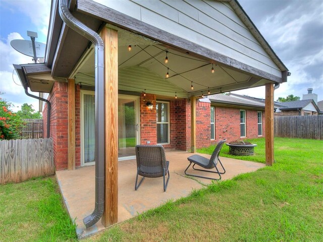 1408 Chimney Hill Rd, Yukon, OK 73099 - fenced backyard featuring an outdoor fire pit and a patio area