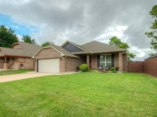 2204 Cale Cv, Yukon, OK 73099 - view of front facade featuring an attached garage, a shingled roof, concrete driveway, and brick siding
