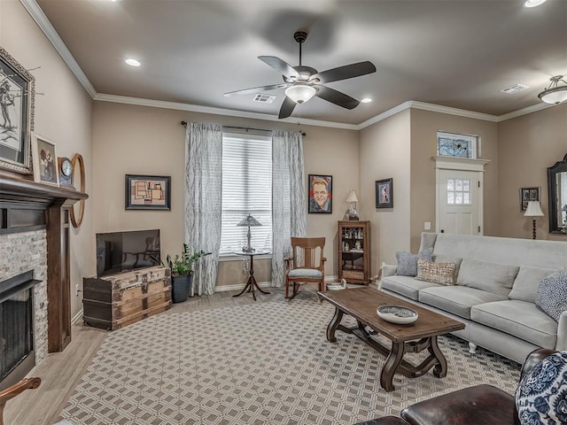 2204 Cale Cv, Yukon, OK 73099 - living area with a fireplace, ceiling fan, recessed lighting, light wood-style floors, and ornamental molding