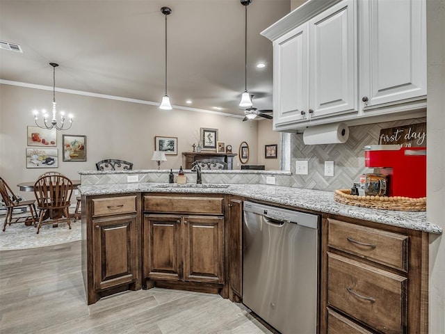 2204 Cale Cv, Yukon, OK 73099 - kitchen featuring stainless steel dishwasher, a peninsula, decorative backsplash, a ceiling fan, and white cabinets