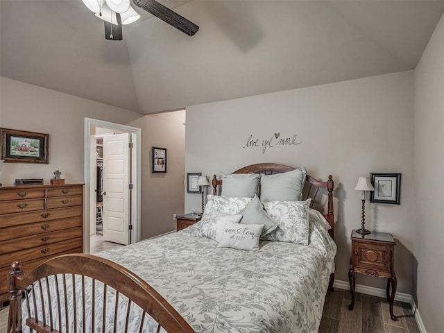 2204 Cale Cv, Yukon, OK 73099 - bedroom featuring vaulted ceiling, wood finished floors, a walk in closet, a ceiling fan, and a closet