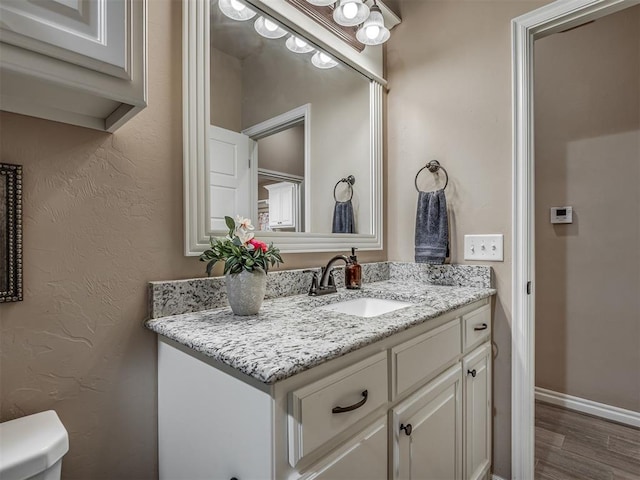 2204 Cale Cv, Yukon, OK 73099 - bathroom featuring vanity and wood finished floors