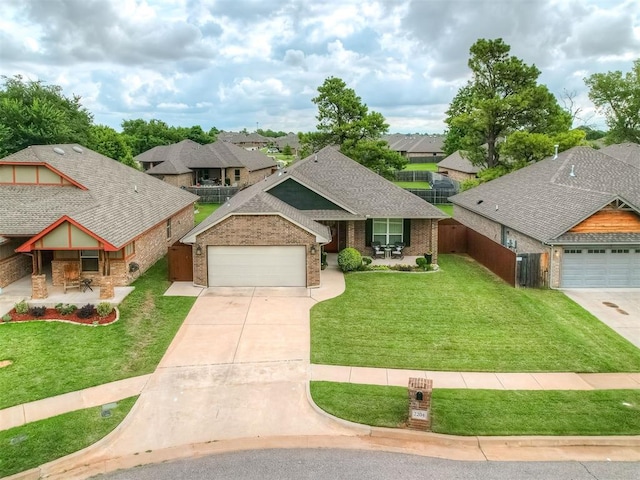2204 Cale Cv, Yukon, OK 73099 - view of front of property with driveway, brick siding, an attached garage, a residential view, and a shingled roof