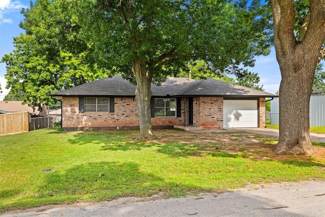311 N Monroe Ave, Blanchard, OK 73010 - view of front of property with an attached garage, brick siding, roof with shingles, and driveway