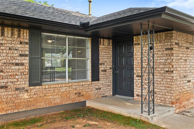 311 N Monroe Ave, Blanchard, OK 73010 - property entrance featuring brick siding and a shingled roof
