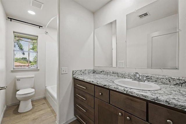 311 N Monroe Ave, Blanchard, OK 73010 - full bathroom with vanity, wood finished floors, and tub / shower combination