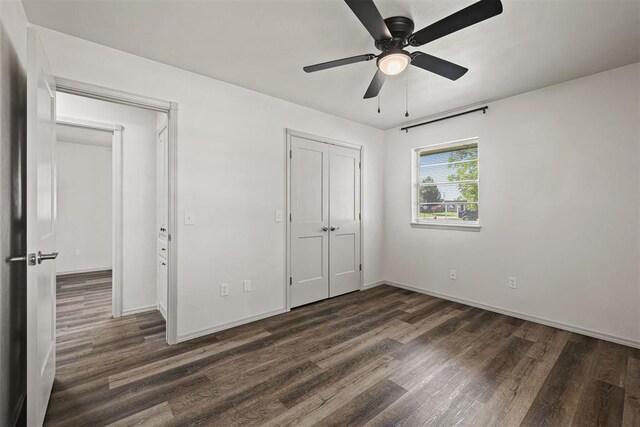 311 N Monroe Ave, Blanchard, OK 73010 - unfurnished bedroom with dark wood finished floors, a closet, and a ceiling fan