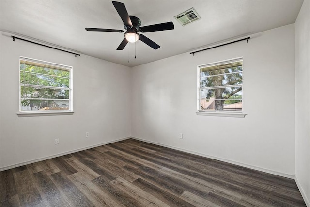 311 N Monroe Ave, Blanchard, OK 73010 - empty room with healthy amount of natural light, dark wood-type flooring, and a ceiling fan