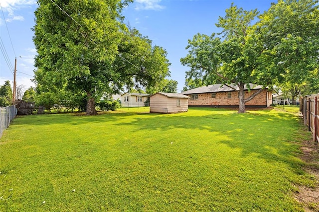 311 N Monroe Ave, Blanchard, OK 73010 - fenced backyard with a storage unit