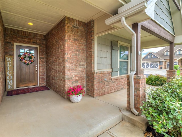 12917 Treemont Ln, Oklahoma City, OK 73142 - view of exterior entry featuring a porch and brick siding