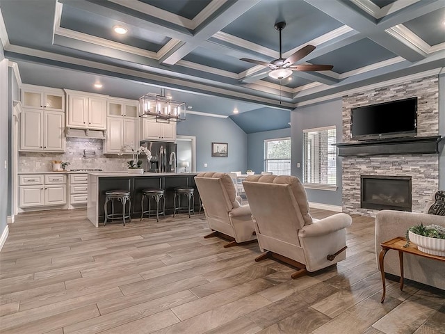 12917 Treemont Ln, Oklahoma City, OK 73142 - living area with ornamental molding, a ceiling fan, a fireplace, light wood-style flooring, and beam ceiling