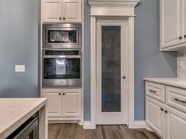 12917 Treemont Ln, Oklahoma City, OK 73142 - kitchen with appliances with stainless steel finishes, white cabinets, and dark wood-style flooring