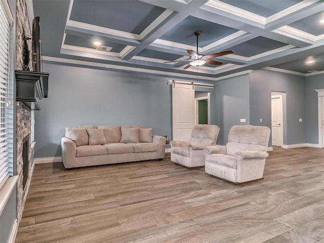 12917 Treemont Ln, Oklahoma City, OK 73142 - living room featuring a ceiling fan, a barn door, a fireplace, crown molding, and coffered ceiling
