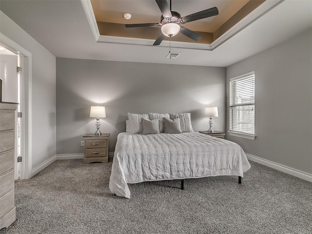 12917 Treemont Ln, Oklahoma City, OK 73142 - carpeted bedroom featuring a tray ceiling and a ceiling fan