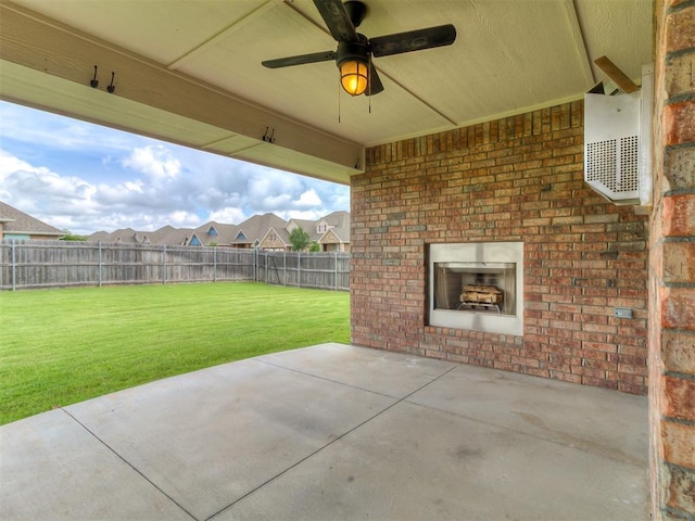12917 Treemont Ln, Oklahoma City, OK 73142 - fenced backyard featuring an outdoor brick fireplace, a patio, and ceiling fan