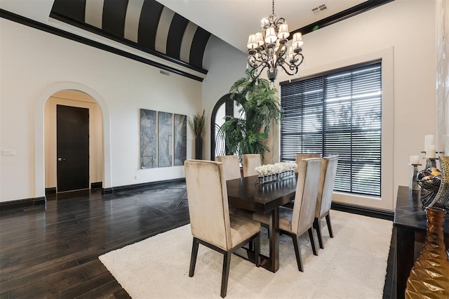 3617 Stagmoor Rd, Edmond, OK 73034 - dining space featuring arched walkways, a chandelier, and wood finished floors