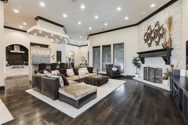 3617 Stagmoor Rd, Edmond, OK 73034 - living area featuring ornamental molding, arched walkways, a fireplace, wood finished floors, and recessed lighting