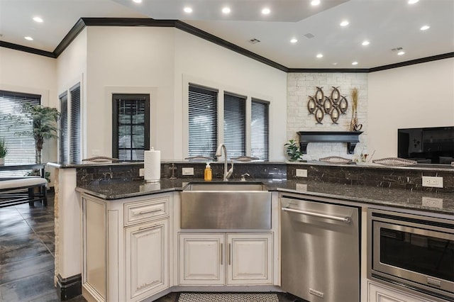 3617 Stagmoor Rd, Edmond, OK 73034 - kitchen with appliances with stainless steel finishes, crown molding, dark stone countertops, open floor plan, and cream cabinets
