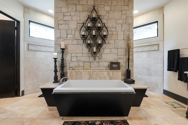 3617 Stagmoor Rd, Edmond, OK 73034 - bathroom featuring a bath, tile patterned floors, and tile walls