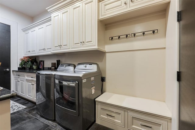 3617 Stagmoor Rd, Edmond, OK 73034 - laundry area featuring cabinet space, washing machine and clothes dryer, and dark tile patterned flooring