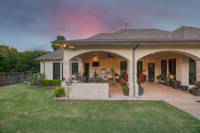 3617 Stagmoor Rd, Edmond, OK 73034 - back of property featuring stucco siding, a patio area, ceiling fan, a bar, and stone siding