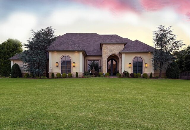 3617 Stagmoor Rd, Edmond, OK 73034 - french country style house featuring stucco siding, stone siding, and a front lawn