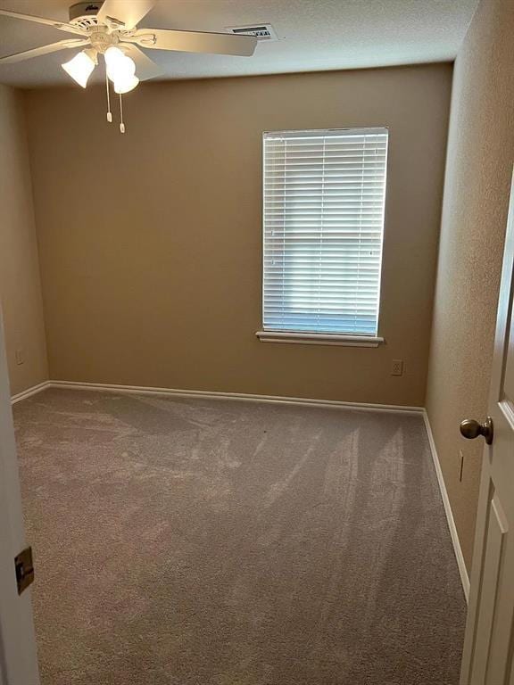916 Beaumont Sq, Norman, OK 73071 - empty room featuring carpet flooring and ceiling fan