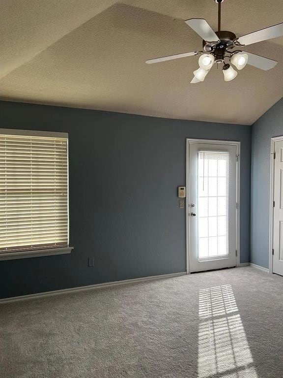 916 Beaumont Sq, Norman, OK 73071 - empty room with a ceiling fan, carpet floors, and vaulted ceiling