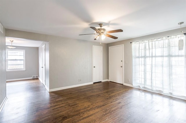 3012 NW 67th St, Oklahoma City, OK 73116 - spare room featuring a ceiling fan and dark wood-type flooring