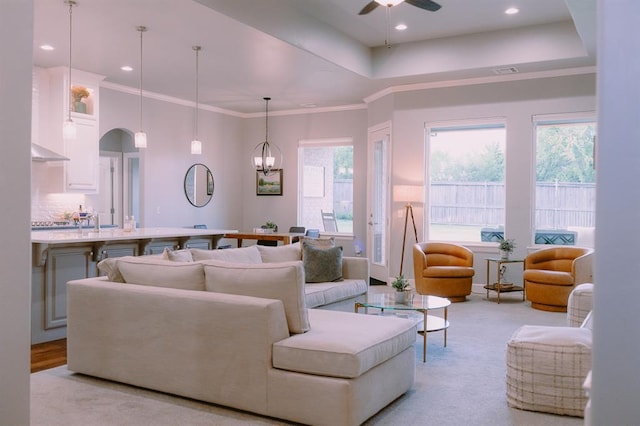 12113 SW 45th Ter, Mustang, OK 73064 - living room with plenty of natural light, a ceiling fan, ornamental molding, light colored carpet, and recessed lighting