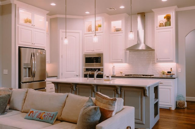 12113 SW 45th Ter, Mustang, OK 73064 - kitchen featuring stainless steel appliances, wall chimney exhaust hood, open floor plan, backsplash, and recessed lighting