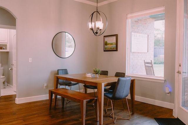 12113 SW 45th Ter, Mustang, OK 73064 - dining space with dark wood-type flooring, arched walkways, and a chandelier